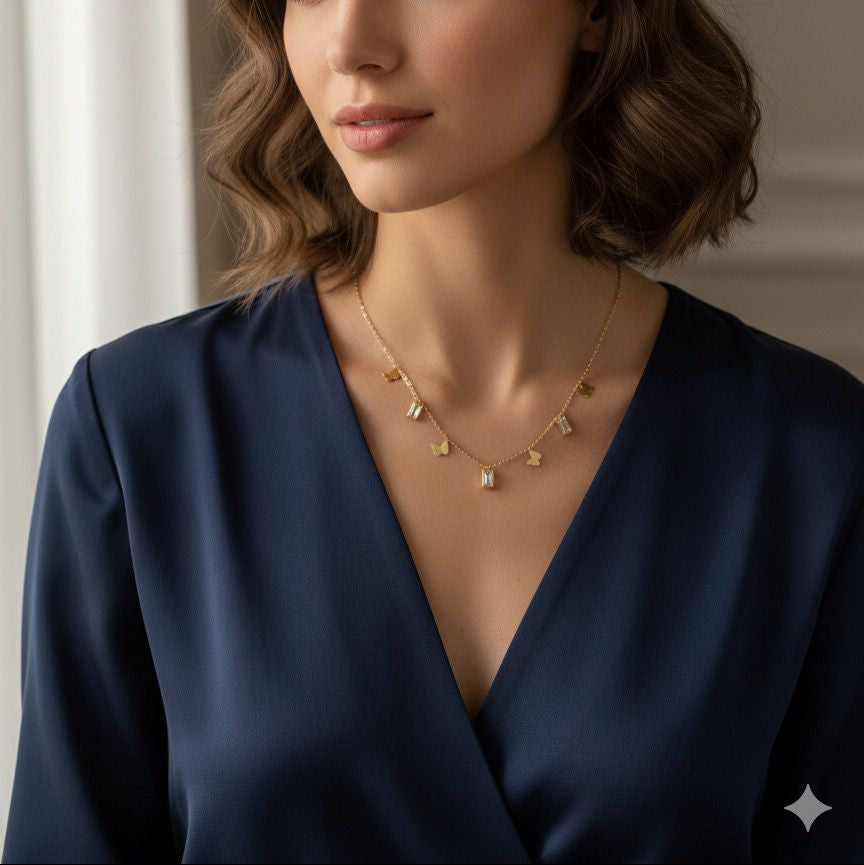 Woman wearing a gold necklace in a softly lit room