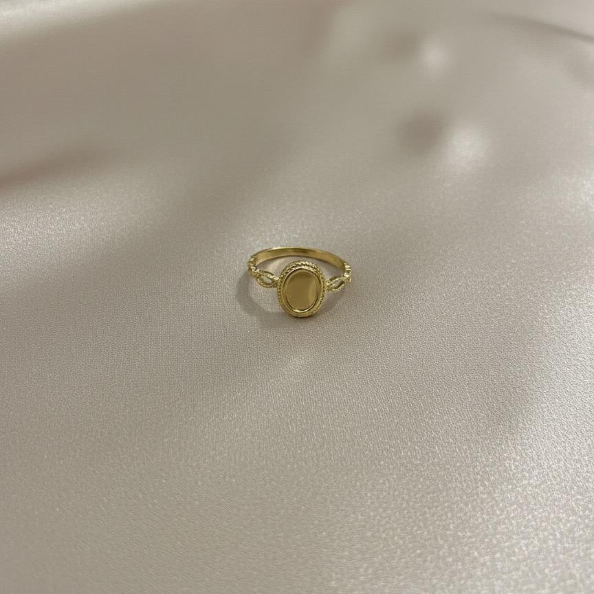 Gold ring on a light beige fabric background